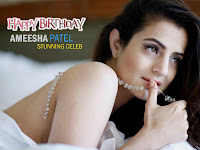 ameesha patel, sexy photo on bed playing with white pearl wreath