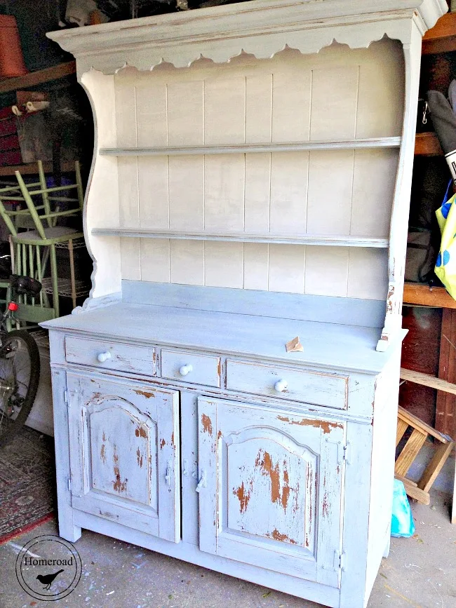 Painted hutch with white interior and light blue background