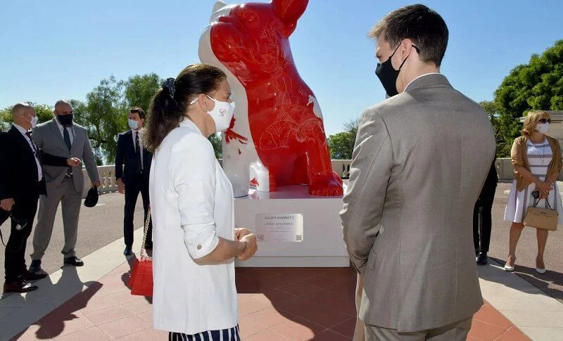 Princess Stephanie, Louis and Marie Ducruet at the inauguration of the sculpture of Doggy John. White jacket, striped pants, red bag