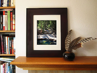 The Roaring Fork River is banked by rocky granite outcrops and a woodland pine forest.