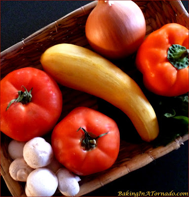 Bountiful Stuffed Tomatoes: filled with garden vegetables, parmesan and croutons, bursting with fresh flavor for a healthy lunch or side dish. | Recipe developed by www.BakingInATornado.com | #recipe #vegetables