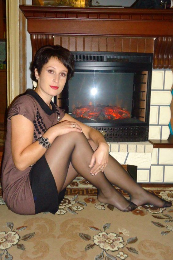 Beautiful woman sit on the floor wearing a cute minidress and black tights