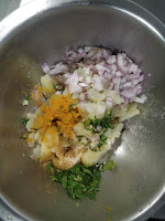 Adding chopped onion green chilli, turmeric powder,cumin powder with mashed potato for aloo paratha stuffing