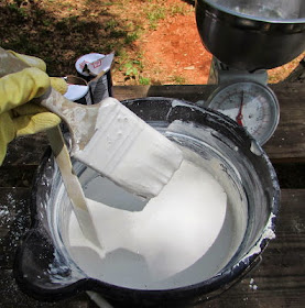 Mixing whitewash to paint the inside of the chicken coop.
