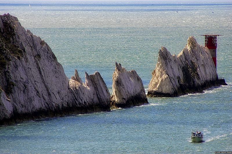 "The Needles" are chalk stacks jutting out of the sea at Alum Bay on the western end of Isle of Wight, England. There's a gap between these chalk stacks where a narrow pillar or chalk used to stand until it was destroyed in a storm in 1764. This narrow pillar gave this site its name, "The Needles".