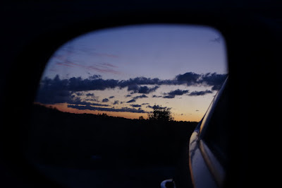 leaving sunset behind in a rear view mirror