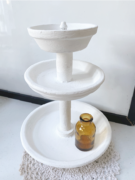 tiered tray with amber bottle
