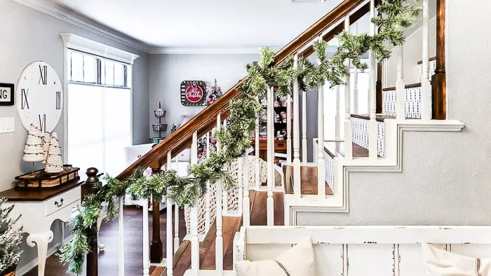 pine garland draped on stair banister
