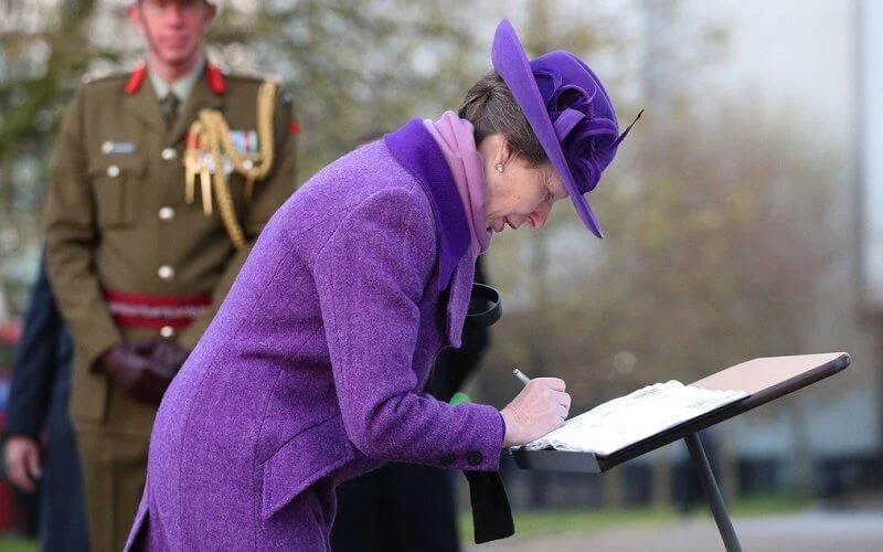 Princess Anne wore an eye-catching purple coat and matching hat, a pale lilac scarf and black knee-high boots