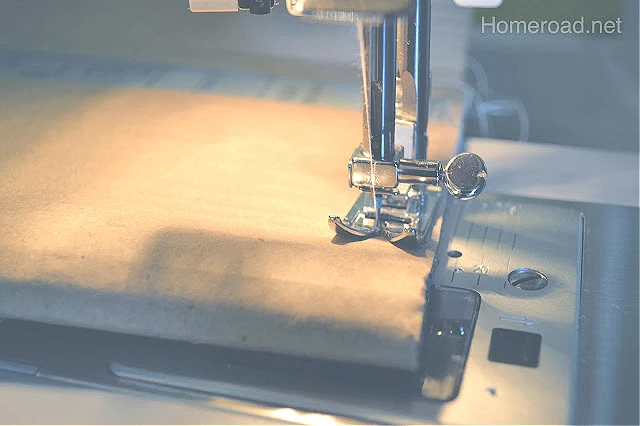 Sewing machine sewing the cardboard