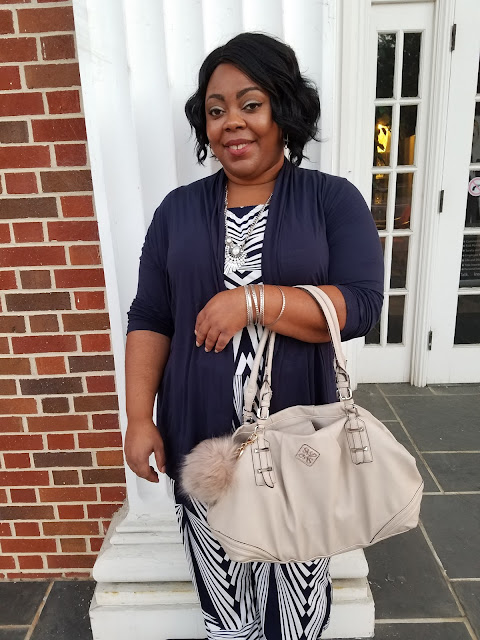 Plus size blogger, navy open front cardigan, geo-print jumpsuit, nude Vera Wang handbag.