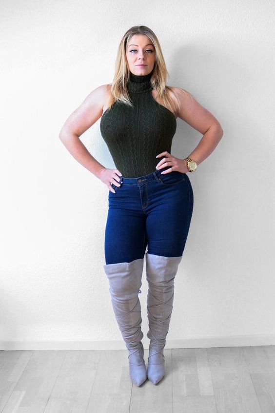 Plus size woman wearing jeans and gray suede boots
