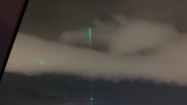 Eye witness in the UK witnesses a green laser coming from a UFO.
