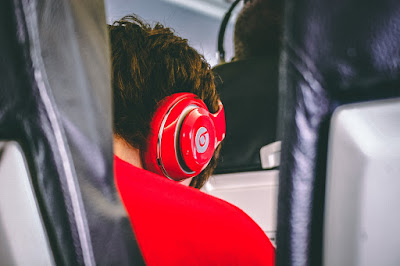 Child wearing headphones while travelling