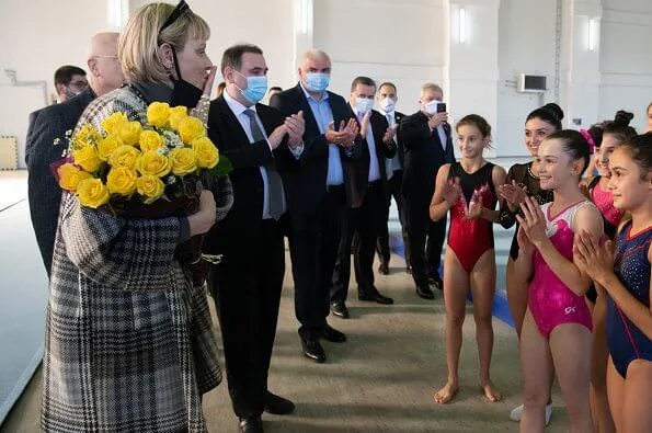 Princess Charlene visited the Olympic Village in Tbilisi and its sports facilities. Charlene wore a traford plaid fringe poncho from Loro Piana