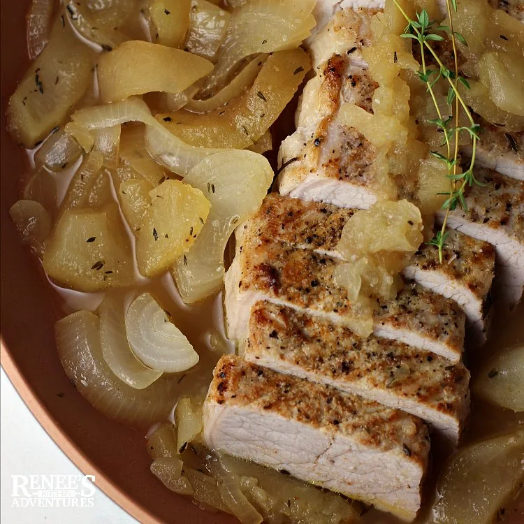 Pork Loin Filet with Apples and Onions by Renee's Kitchen Adventures sliced pork in pan with apples and onions ready to eat, overhead shot