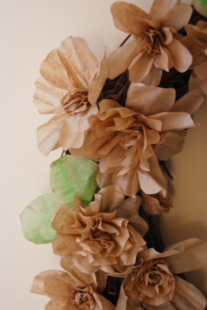 Paper flowers on one side of a large wreath. I like to think of these flowers as representing the differing flower forms in the Peony family... single, semi-double, fully double, Japanese, Anemone and "bomb" shaped.
