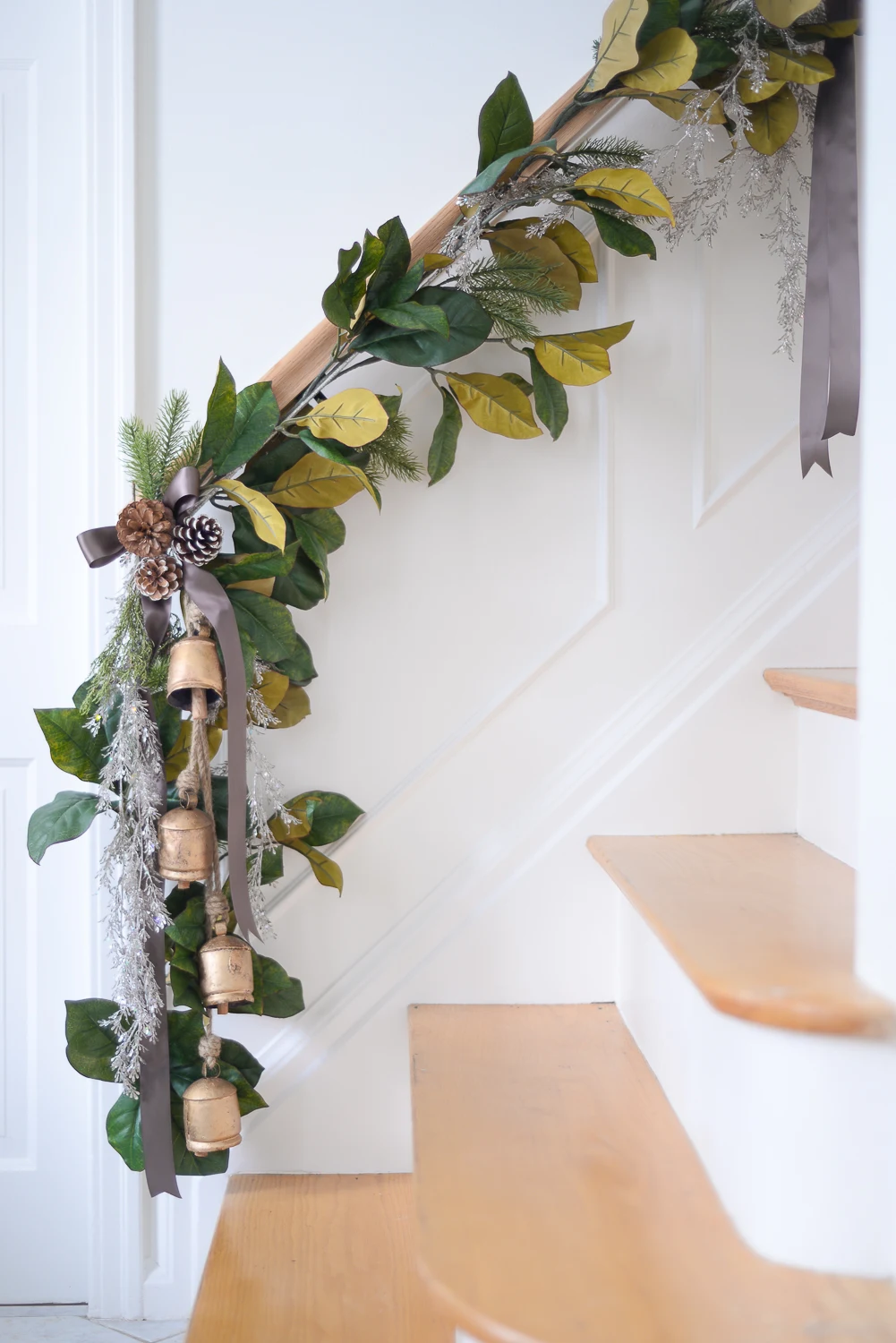 how to hang garland on stairs, stairway garland, garland on stair banister