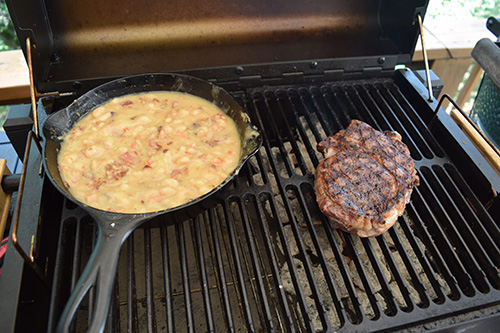 Making white beans and bacon while I grill the steak