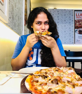 Sandani eating pizza