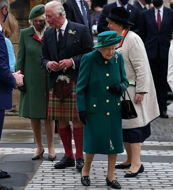 The Queen selected Queen Mary's Diamond Thistle Brooch for her lapel. Prince of Wales and Duchess of Cornwall