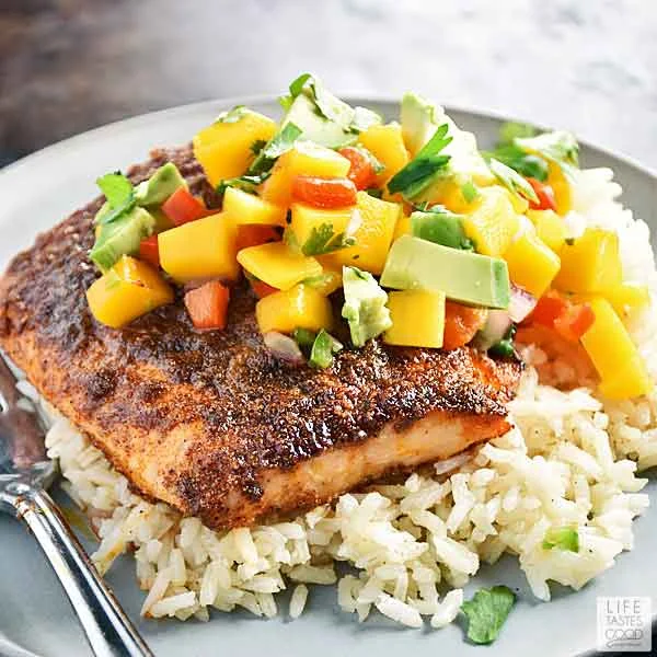 Mango Jalapeno Salsa with Avocado atop a beautiful chili rubbed salmon fillet on a bed of rice