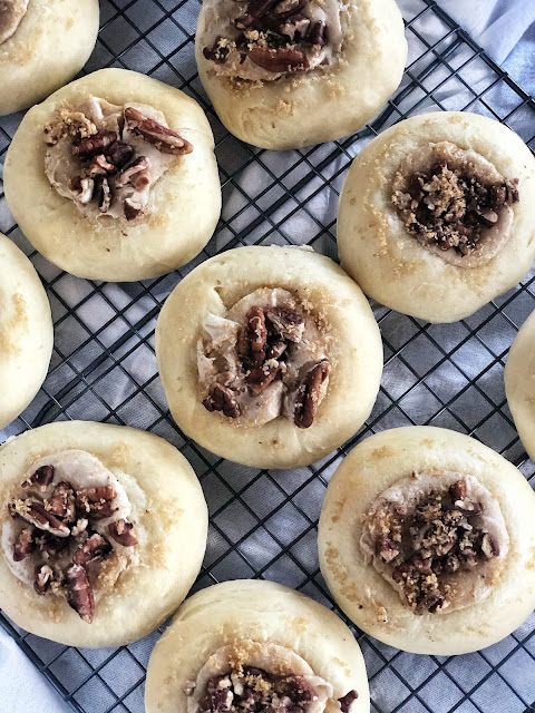 kolaches filled with maple cream cheese filling and sprinkled with pecans and brown sugar