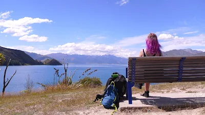 woman on bench looking out to sea