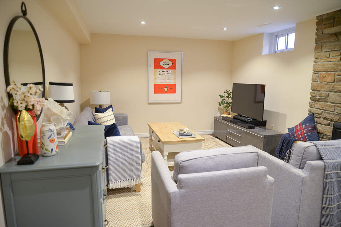 basement update, budget basement makeover, basement living room, coastal vignette, teal dresser, large round mirror over dresser basement update, budget basement makeover, basement living room, coastal vignette, teal dresser, large round mirror over dresser