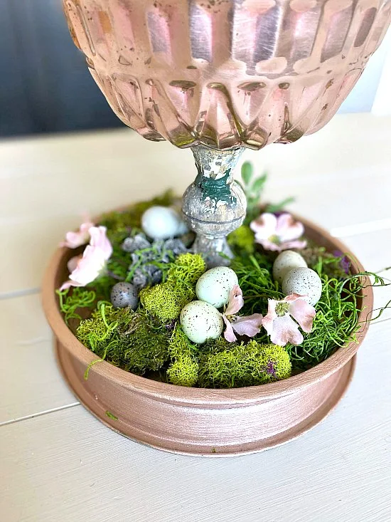tiered tray with moss and flowers