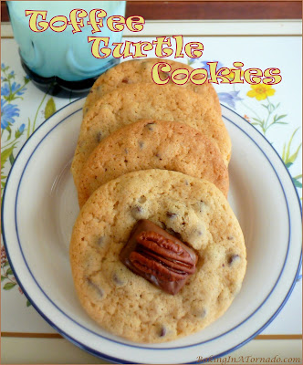 Toffee Turtle Cookies are a cookie reminiscent of a well known candy treat. Pecan and mini chocolate chip cookies are topped with a miniature toffee and pecan half. | Recipe developed by www.BakingInATornado.com | #recipe #chocolate