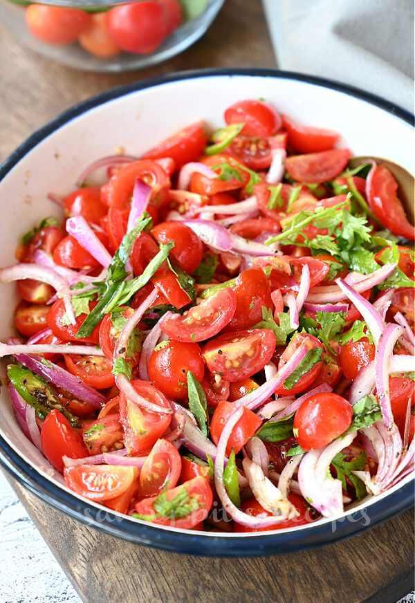 a white bowl with pickled cherry tomatoes