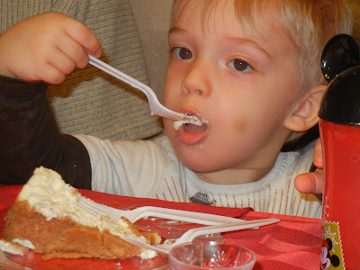 boy eating a slice of cheesecake with a fork 