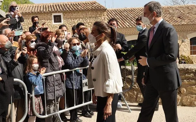 Queen Letizia wore a stripe wool sweater and trousers from Hugo Boss, and new black maysli suede slingback pumps from Manolo Blahnik