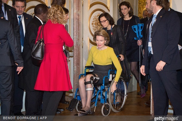 Queen Mathilde of Belgium sitting in a wheelchair, following a knee injury, arrives to attend a conference on Ebola on March 3