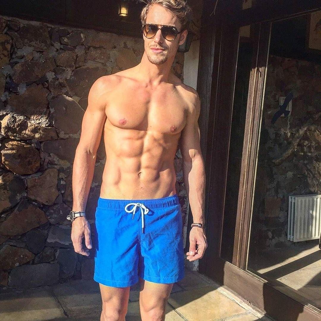 fit-shirtless-blond-luxurious-guy-blue-shorts-sunglasses