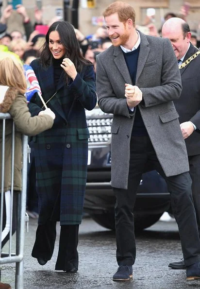 Meghan Markle wore a double-breasted tartan wool-blend coat by Burberry during Edinburgh visit. Meghan carried Strathberry Mini crossbody bag