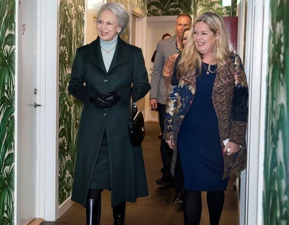 Princess Benedikte wore a green wool cashmere coat, and blue cashmere sweater, and gold diamond necklace. The Princess wore black leather boots