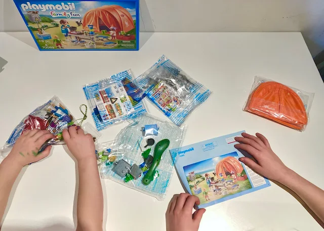 The contents of the Family Camping Trip set straight from the box includes several clear bags with small pieces in and instructions for assembly