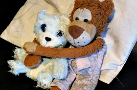 2 soft toys. A monkey and a blue polar bear