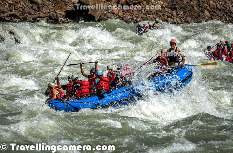 Rafting or white water rafting is one of the challenging recreational outdoor activity using an inflatable raft to navigate a river or other bodies of water having different levels of water-current. This is usually done on white water or different degrees of rough water, in order to thrill and excite the raft passengers. Rafting is considered an extreme sport, as it can be dangerous as times. This Photo Journey shares some of the photographs of Rafting in Risikesh, which is one of the popular places in India to do White Water Rafting.Recently we were in Rishikesh with office friends and Rafting was one of the top item in our list of things we wanted to do. We started in bus from Aspen Camps in Rishikesh and then boarded to jeeps with rafts. We had to start from Marine Drive which is a huge Ganges beach with enough space for folks to prepare and get started. Marine Drive is a place, strategically identified to start Rafting. Shivpuri is another preferred place to start Rafting. Idea is to make people comfortable with various types of water-rapids and then gradually start enjoying various stretches in river. Ganges provides a good range of water rapids and makes rafting an unmatchable experience.Rishieksh is one of the main places to do rafting in North India. Long time back I had done rafting in Vyas River near Kullu and that time all other rafters were professionals and I was covering a particular camp for Tourism Development program. Since I was not much involved in rafting activities, I couldn't enjoy it much that time. At Rishikesh, we had a wonderful coach/leader, who made rafting experience as great fun.After reaching Marine Drive Ganges beach, everyone of us got life jackets, a pedal and helmet. All three important things were with us and coach told us the best ways of using these three. All set with tight life-jacket, well settled helmet and appropriately gripped pedals we stepped into the raft after cleaning our feet in ganges water. It's recommended not to bring sand particles inside the raft, which can harm later. The coach threw chilling ganges water on us to start the journey in chilled water of ganges with different current levels. Coach with one of other Rafting professional entered into the raft. Then he briefed everyone of us about different commands like fast forward, move backward, stop etc. Initially it was difficult for us to gram every details of each command, but every command was very important for best rafting experience.Apart from basic Rafting commands, coach/leader also tells about basic rules of White Water Rafting. He also understands about each person sitting in the raft about their past experience with water. He also shares some basic steps for people who are not comfortable while sitting in raft. Of course, there are some standard rules to sit on a raft and make yourself comfortable even when body needs to stick with raft through feet in a particpular position. The Thumb rule is to listen your coach and follow him without any alternation, even in difficult situation. Idea is to trust the coach/Leader and follow his/her commands with any panic.So we started with baby steps and raft started moving towards Rishikesh (Lakshman Jhoola). For first 10 minutes, we were really slow and it was more of practice session, wehere coach was making us prepared for following his commands throughout the whole stretch we had to do in river. After practicing all the commands and moving our raft in circle, coach/leader asked us to stand on boundaries of raft and balance with pedal mounted on raft top. None of us could gather courage to stand on the boundaries and negotiated with coach/leader to stand inside the raft and try to balance with pedals. It was one of the major test for us and raft moves a lot. Many times, some of us stumbled and others were getting impacted because of imbalance. This task completed and coach/leader asked us to move forward.First we encountered Good Morning Rapid which is the beginning of Rafting experience. Good Morning rapid always come of the way and it doesn't matter that what was your starting point :). It was very basic but yet exciting because of first encounter with relatively fast flow of water-waves. Before hitting the rapid, some of the screaming while others were laughing to hide the fear :)All these photograph in this Photo Journey are clicked day before we did rafting. One day before we did rafting, we kept going to different places around river bed to shoot rafts sailing through high rapids of Ganges white water. Above photograph shows one of the raft getting up side down at Golf Course. One of the other leader jumped into the water to rescue raft and then every rafter. Within 5-8 minutes everyone was back on top of raft and moved forward towards Laxman Jhoola, which was end point. In such situations, ideally, everyone should listen carefully to what leader says and follow with panic. Things can get worse in case of avoidance of leader commands.The modern rafts are inflatable boats, consisting of very durable, multi-layered rubberized (hypalon) or vinyl fabrics (PVC) with several independent air chambers. The length varies between 3.5 meters and 6 meters, the width between 1.8 meters and 2.5 meters. The exception to this size rule is usually the packraft, which is designed as a portable single-person raft and may be as small as 1.5 metres long and weigh as little as 1.8 kilograms.Rafts come in a few different forms. In Europe and Australasia, the most common is the symmetrical raft steered with a paddle at the stern. Other types are the asymmetrical, rudder-controlled raft and the symmetrical raft with central helm (oars) or Stern Mounts with the oar frame located at the rear of the raft. Rafts are usually propelled with ordinary paddles and or oars and typically hold 4 to 12 persons. In Russia, rafts are often hand made and are often a catamaran style with two inflatable tubes attached to a frame. Pairs of paddlers navigate on these rafts. Catamaran style rafts have become popular in the western United States as well, but are typically rowed instead of paddled.Check out more at - http://en.wikipedia.org/wiki/RaftingAfter Good-Morning rapid, we crossed - Black Money, Three Blind Miles, Cross Fire, Shivpuri, Return to center, Roller Coaster, Tea off, Golf Course, Club House, Initiation, Body Surfing, maggie point & Cliff jumping, Double Trouble, Hilton and fianally Ram Jhoola. I went till Golf Course only and most of the other rafts from our group ended at Lakshman Jhoola.The most suitable time for River Rafting in Rishikesh is from September to November and from March to April-May. One of the best rivers in the world to experience the sheer exhilaration of white water rafting, it is the sheer invincible power of the Ganga river that often attracts the adventurer to the challenging sport of river rafting at Rishikesh.Generally White Water Rapids are divided into 6 levels of difficulty.Grade 1: Very small rough areas, might require slight maneuvering. (Skill Level required is very BasicGrade 2: Some rough water, maybe some rocks, might require some maneuvering. (Skill level: basic paddling skillGrade 3: Whitewater, small waves, maybe a small drop, but no considerable danger. May require significant maneuvering. (Skill level: experienced paddling skills)Grade 4: Whitewater, medium waves, maybe rocks, maybe a considerable drop, sharp maneuvers may be needed. (Skill level: whitewater experi\\Grade 5: Whitewater, large waves, large volume, possibility of large rocks and hazards, possibility of a large drop, requires precise maneuvering. (Skill level: advanced whitewater experience)Grade 6: Class 6 rapids are considered to be so dangerous that they are effectively unnavigable on a reliably safe basis. Rafters can expect to encounter substantial whitewater, huge waves, huge rocks and hazards, and/or substantial drops that will impart severe impacts beyond the structural capacities and impact ratings of almost all rafting equipment. Traversing a Class 6 rapid has a dramatically increased likelihood of ending in serious injury or death compared to lesser classes. (Skill level: successful completion of a Class 6 rapid without serious injury or death is widely considered to be a matter of great luck or extreme skill and is considered by some as a suicidal venture)In Rishikesh, we have crossed rapids of Level-3 difficulty as max. But it was great fun to face level three rapids. Water comes on to your body and pushes back and sometimes people get down into the water due to thrust.White water rafting can be a dangerous sport at times, especially if basic safety precautions are not observed. Both commercial and private trips have seen their share of injuries and fatalities, though private travel has typically been associated with greater risk. Depending on the area, safety regulations covering raft operators may exist in legislation. These range from certification of outfitters, rafts, and raft leaders, to more stringent regulations about equipment and procedures. It is generally advisable to discuss safety measures with a rafting operator before signing on for a trip. The equipment used and the qualifications of the company and raft guides are essential information to be considered.Like most outdoor sports, rafting in general has become safer over the years. Expertise in the sport has increased, and equipment has become more specialized and increased in quality. As a result the difficulty rating of most river runs has changed.
