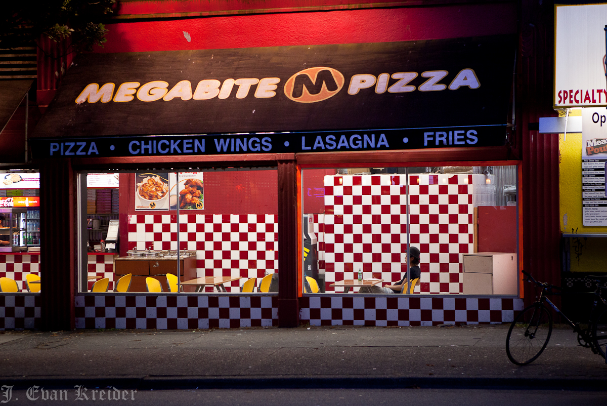 Kreider's Korner Photographs Store fronts at night on Granville Street