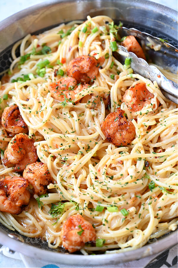 a pan with best bang bang shrimp with pasta and topped with parsley chopped