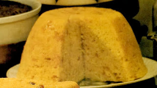 orange and ginger steamed pudding, shown with a slice removed