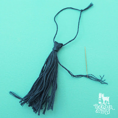 How to make a tassel tutorial, step 4, tie and knot a length of thread to secure the tassel ends