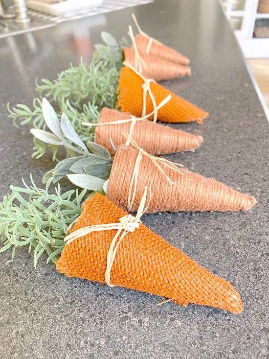 A line of jute and burlap carrots in a row