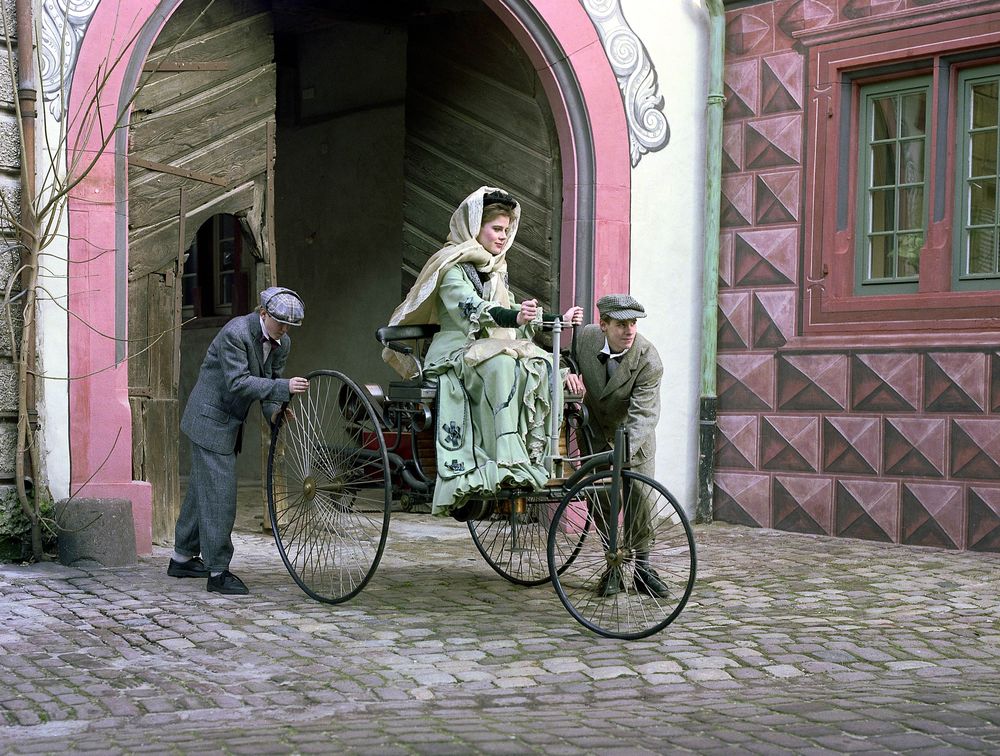 Bertha Benz and her sons Eugen and Richard push-start their car in a reconstructed scene of the long-distance journey from Mannheim to Pforzheim with the Benz Patent Motor Car in 1888