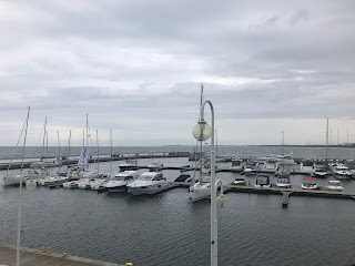some boats in a marina with a cloudy sky above