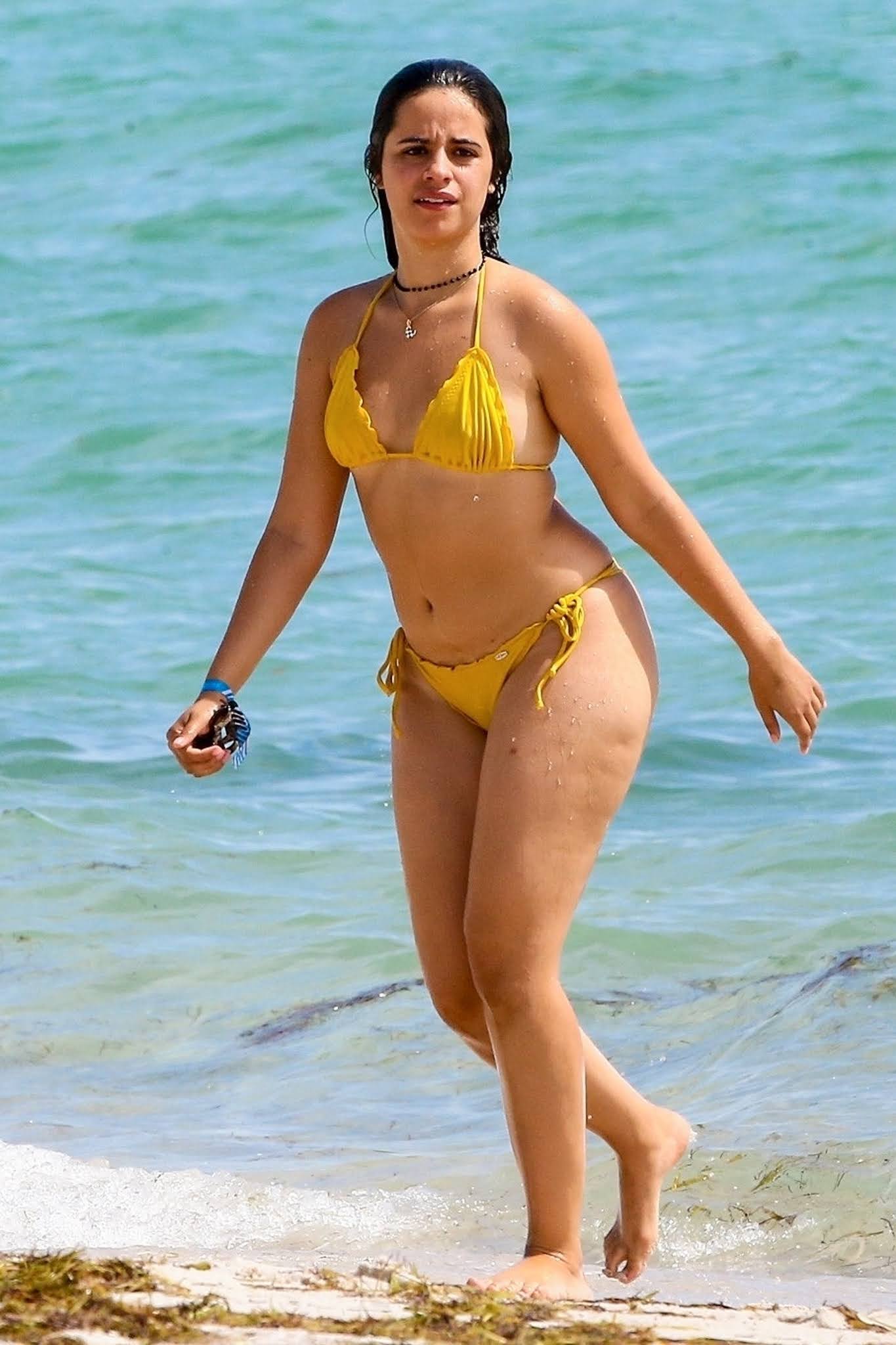 Camila Cabello shows off her sexy curves in a yellow thong bikini on the beach in Miami