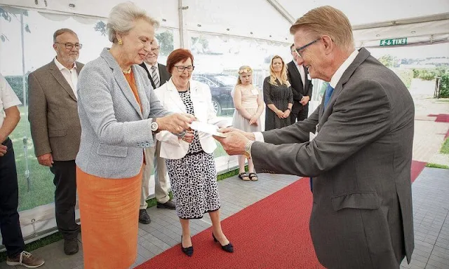 Benedikte wore a orange wool dress and grey jacket.  I.P. Nielsen Foundation provides support to children and young people in Southern Jutland